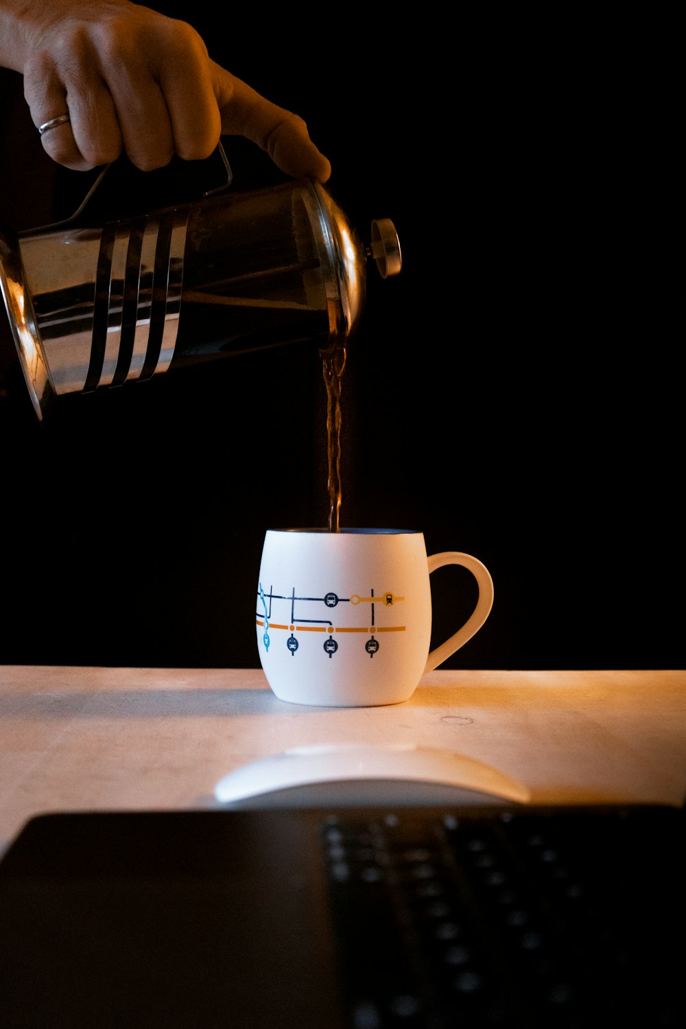 a person pours coffee into a cup