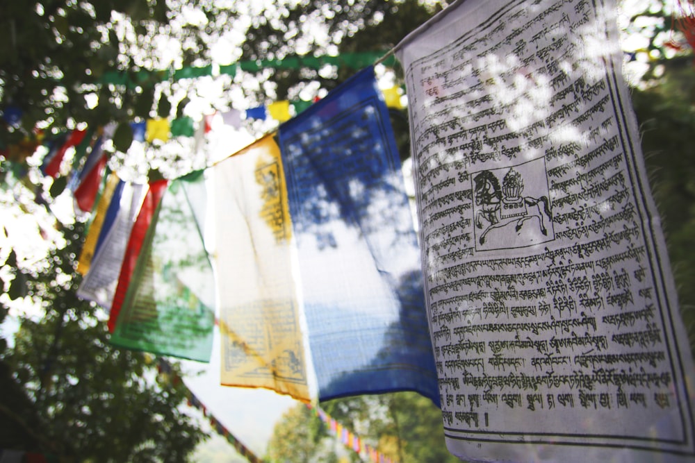 a bunch of colorful flags hanging from a tree