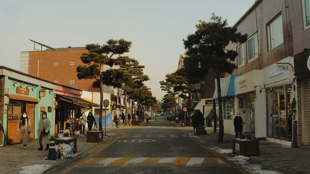 a street with shops and people walking down it