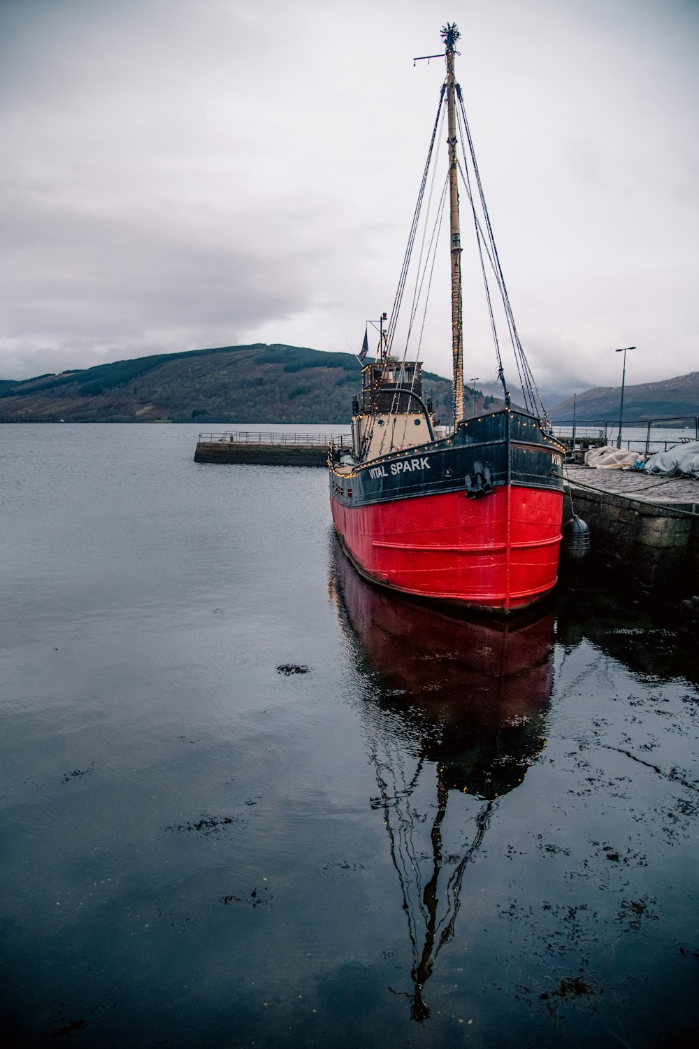 a red and black boat in a body of water