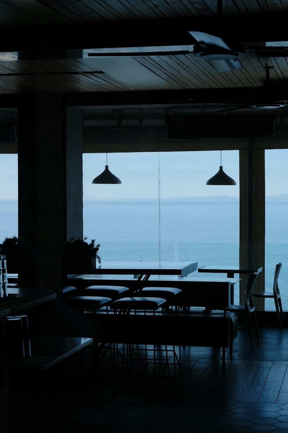 a dark room with a view of the ocean