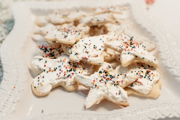 Colorful decorated sugar cookies with intricate icing designs on a white plate.