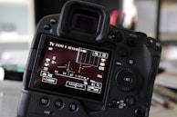 Close-up of camera LCD showing exposure settings during a lesson.