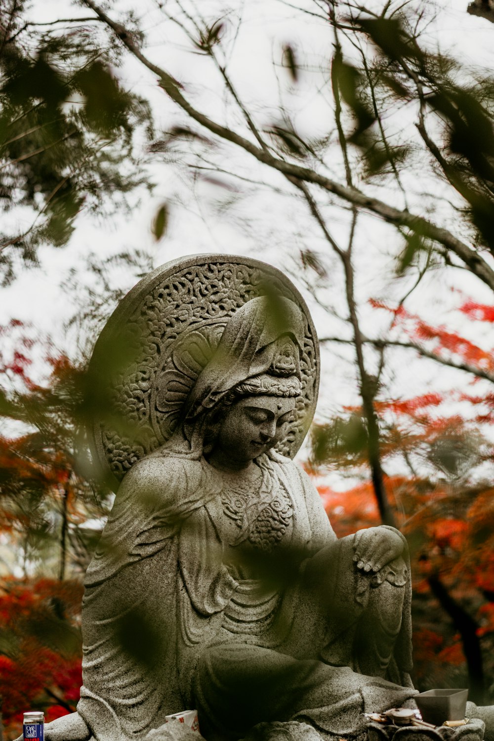 a statue of a person sitting on a rock