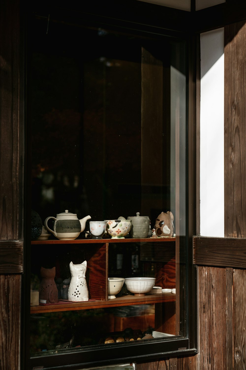 a shelf filled with lots of dishes and cups