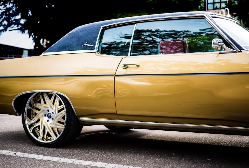 a yellow car parked in a parking lot