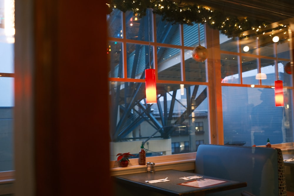 a restaurant with a view of the city outside the window