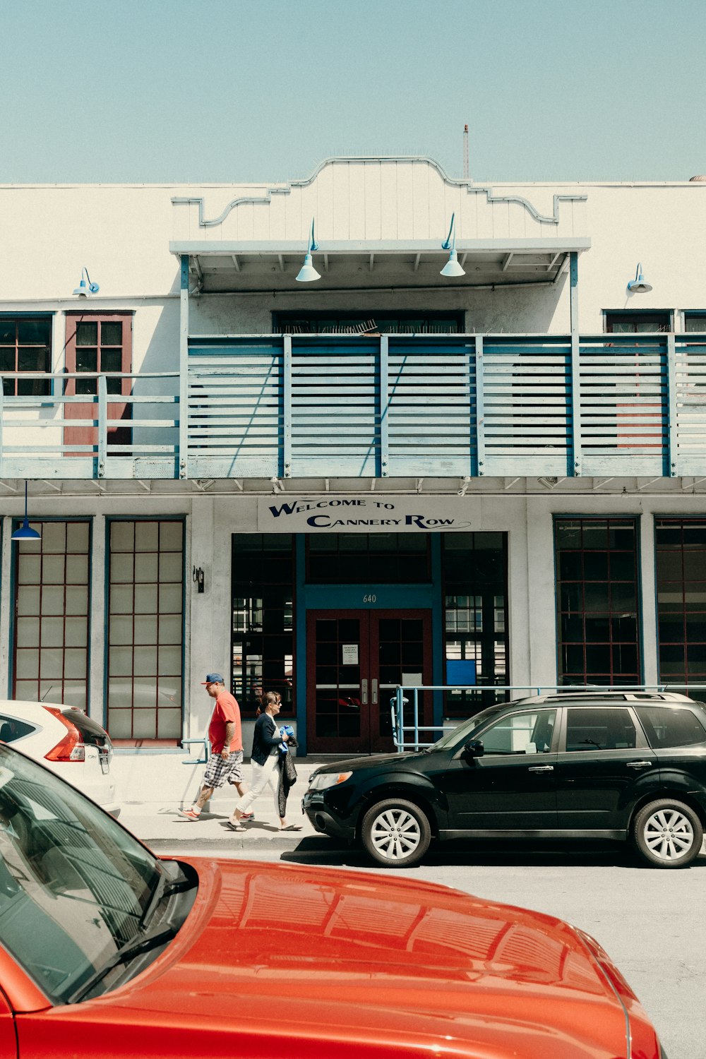 a couple of cars parked in front of a building