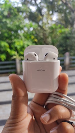 A happy customer wearing heven store earbuds outdoors.