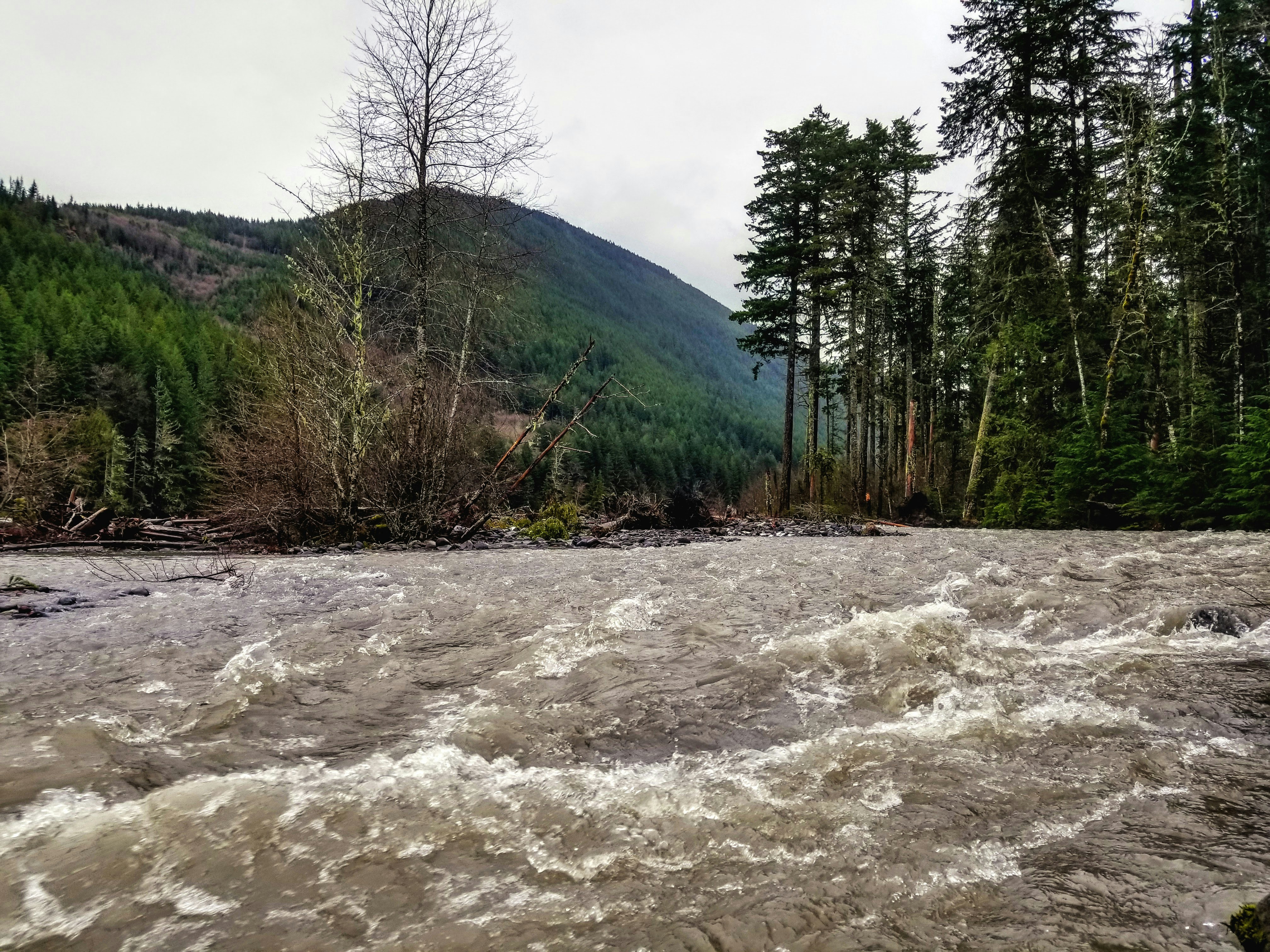 flooded mountain river valley debris