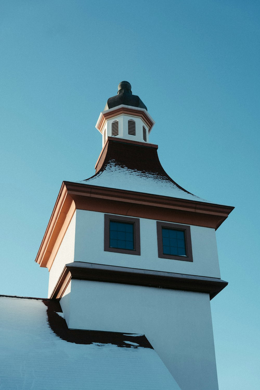 a tall white building with a clock on the top of it