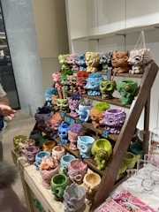 A variety of small personalized pots with colorful lids.