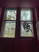 Two-leaf window in a vibrant red shade with clear glass panels.