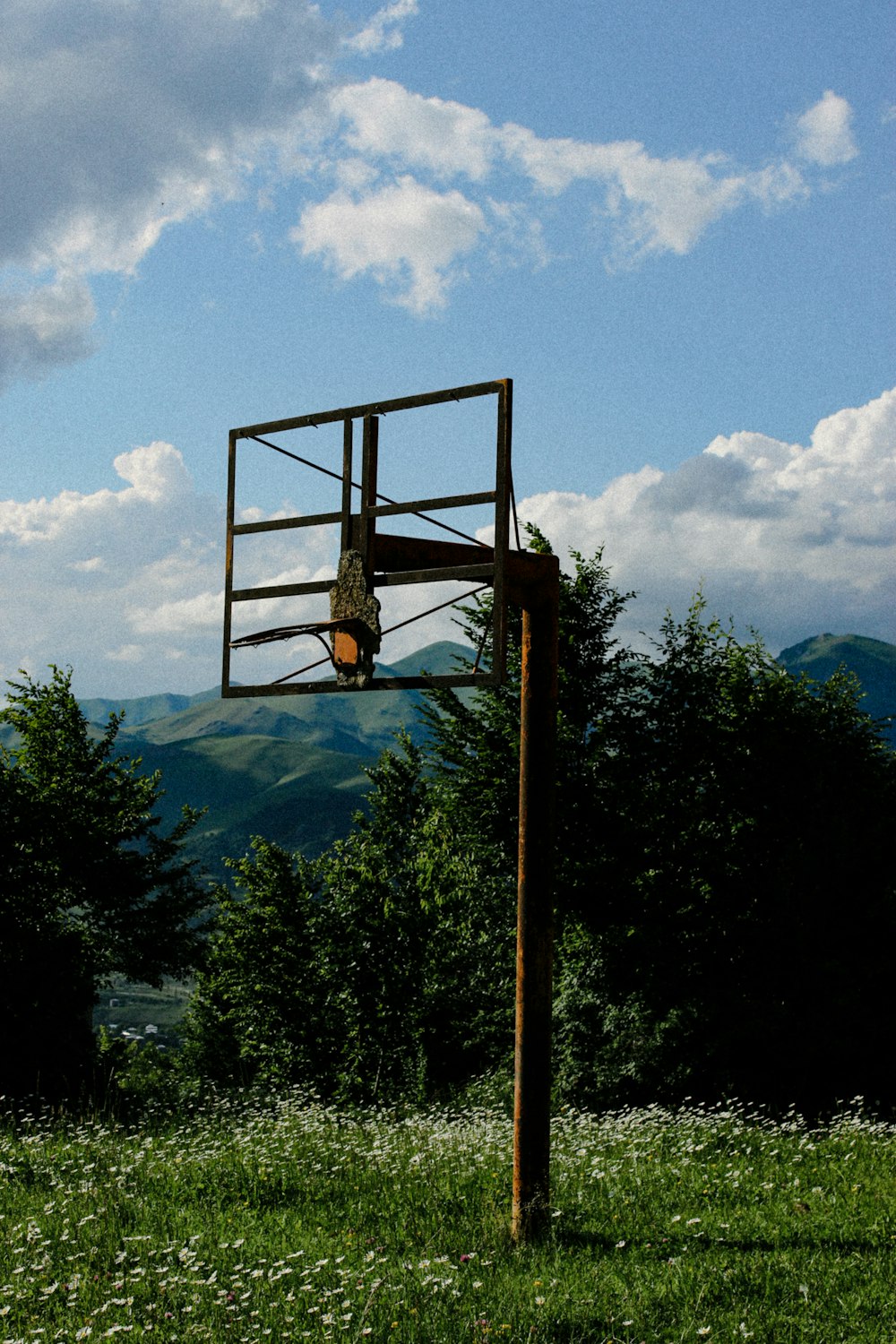 a basketball hoop in the middle of a field