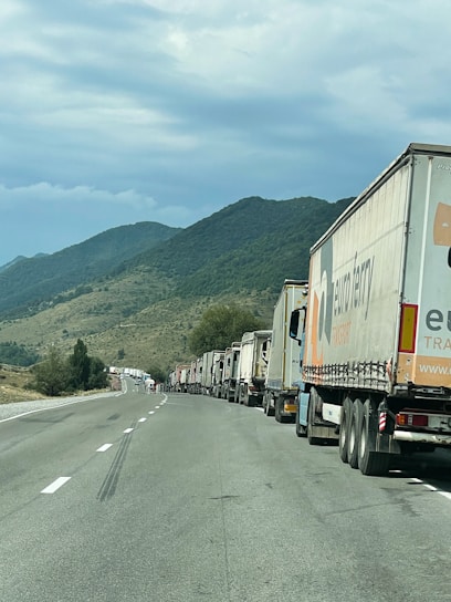 Cargo trucks on a highway transporting goods across borders.