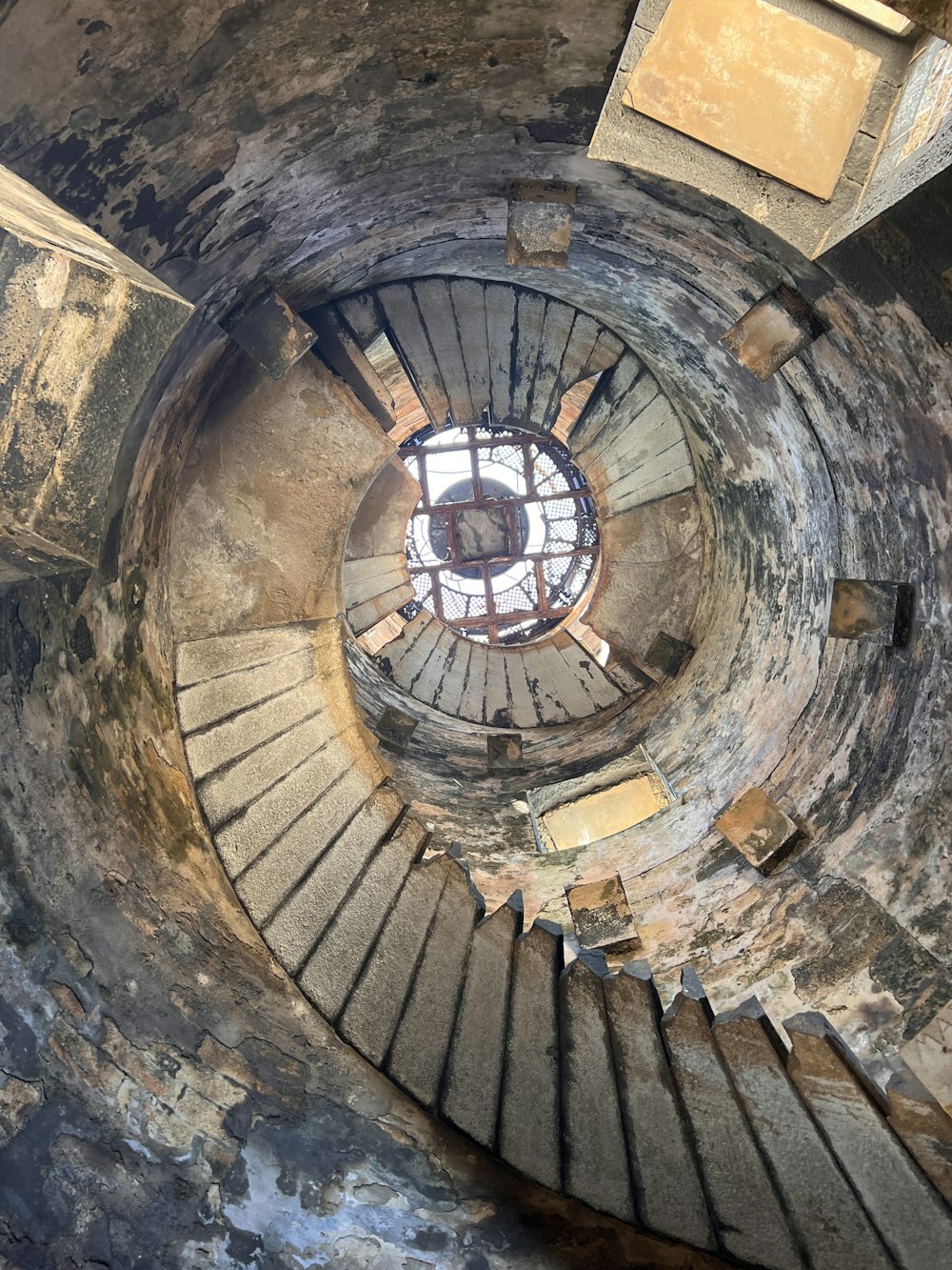 a spiral staircase in an abandoned building