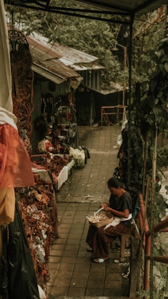 Local women from Lombok weaving intricate rattan patterns outdoors