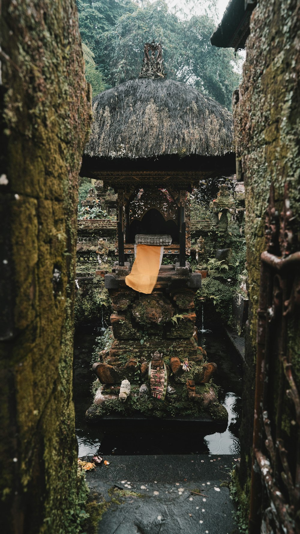 a stone structure with a yellow chair in the middle of it