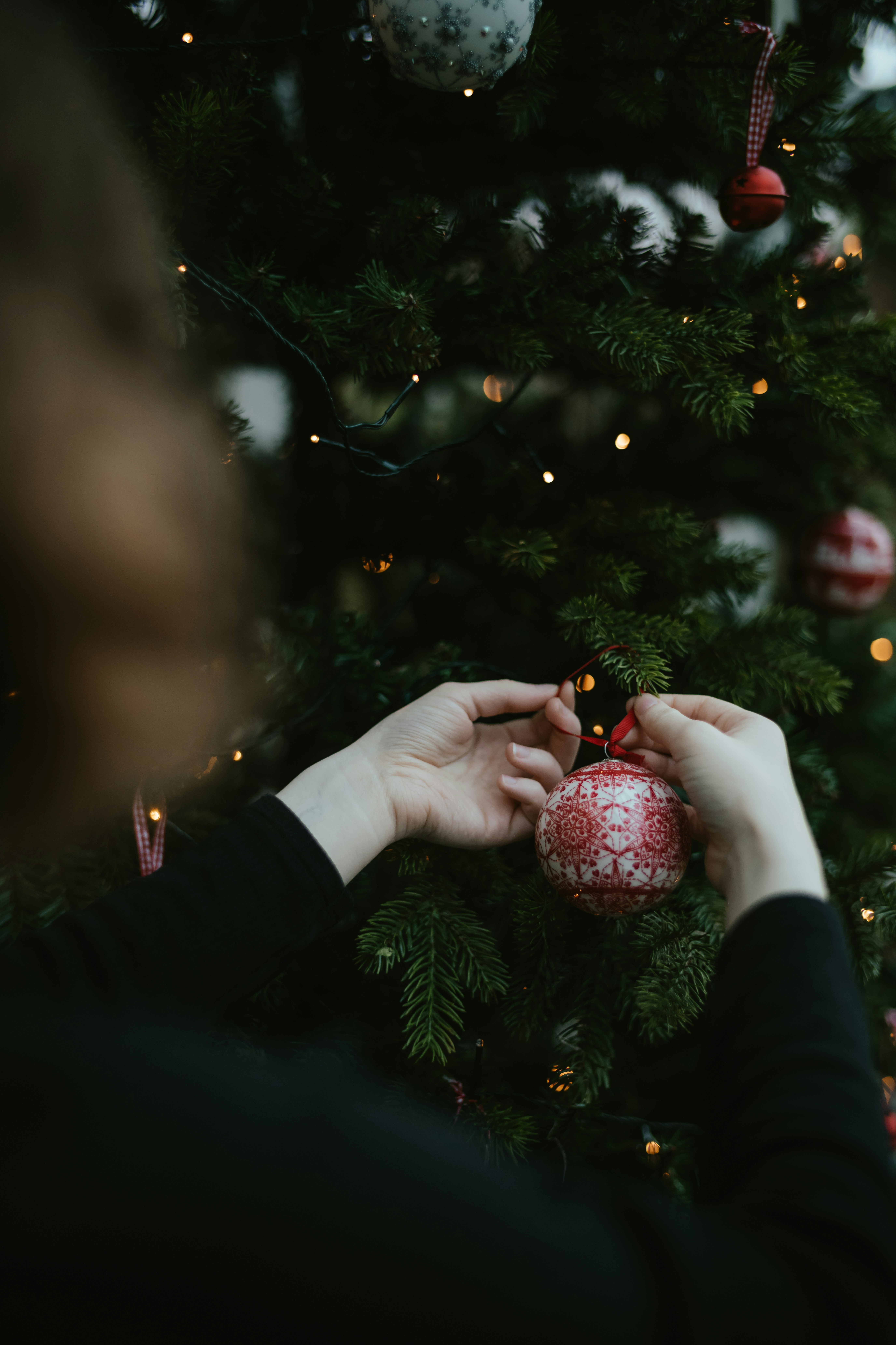 Hand-painted ceramic Christmas ornaments in red and white with snowflake patterns