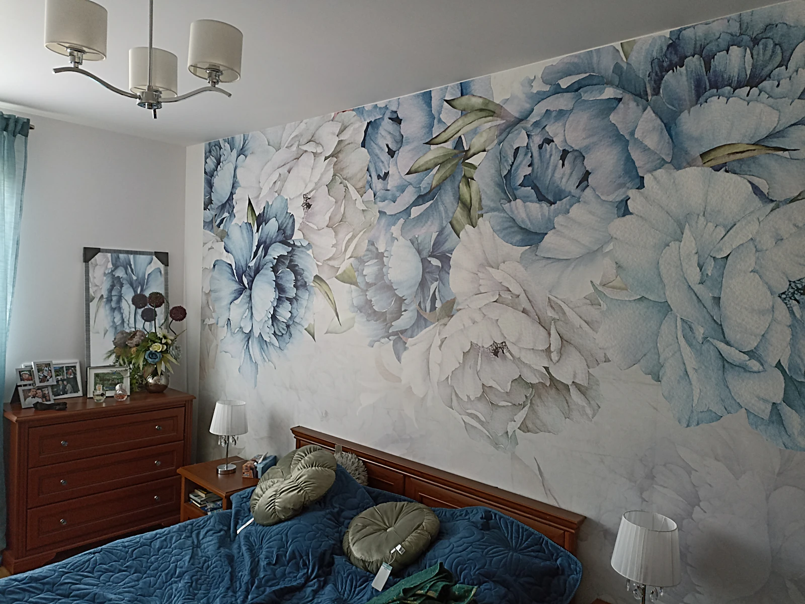 Bedroom wall covered in a large-scale floral wallpaper pattern