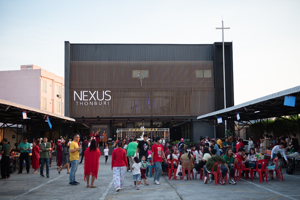 a group of people standing in front of a building