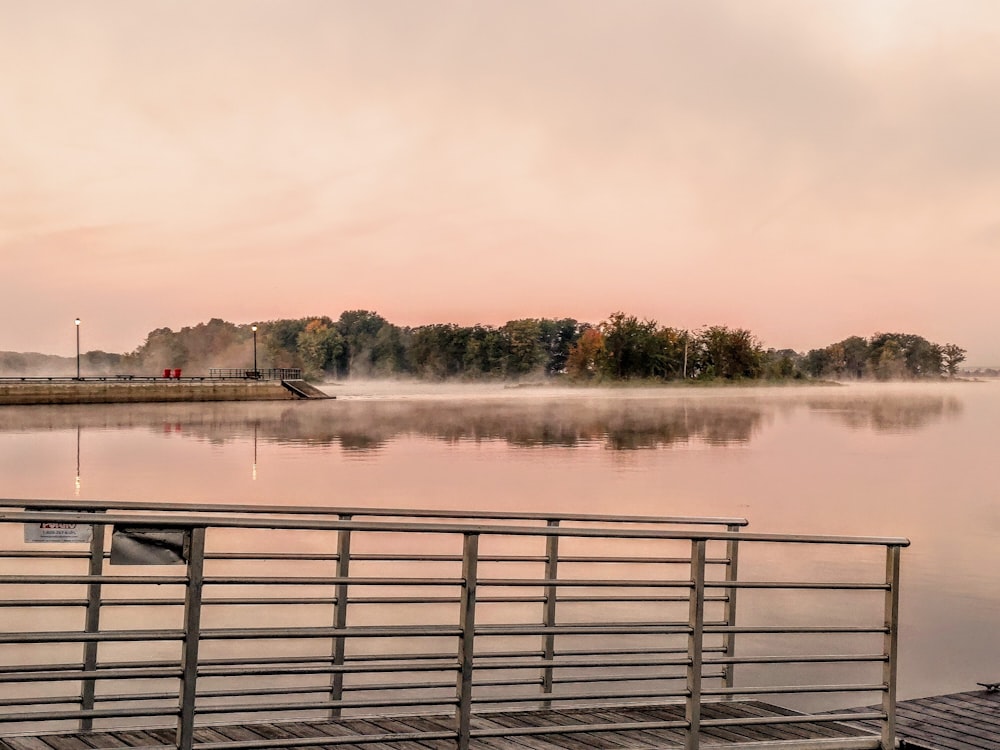 a dock on a lake with a boat in the distance