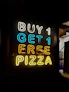 a neon sign that says buy 1 get 1 free pizza