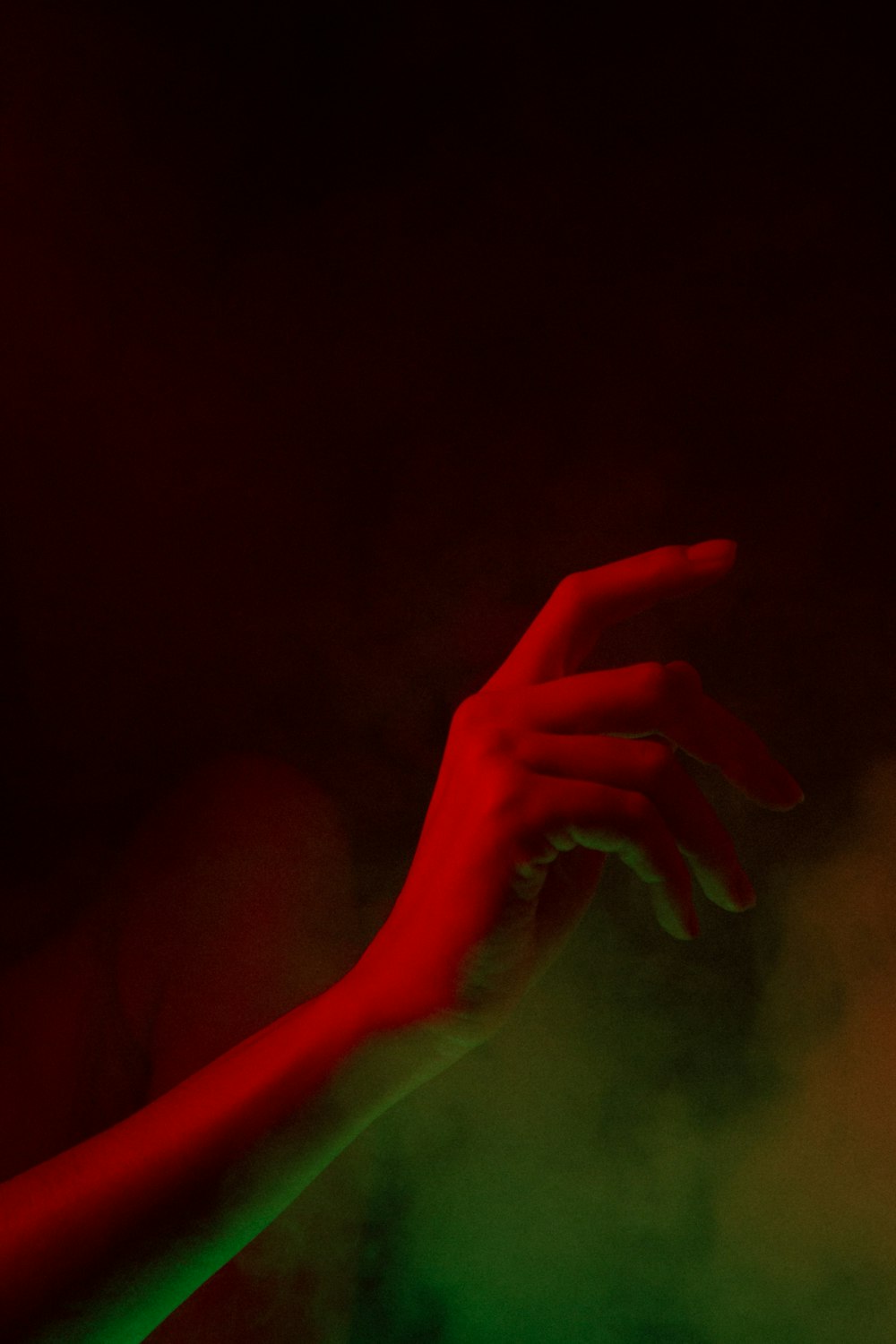 a person's hand reaching for something in the dark