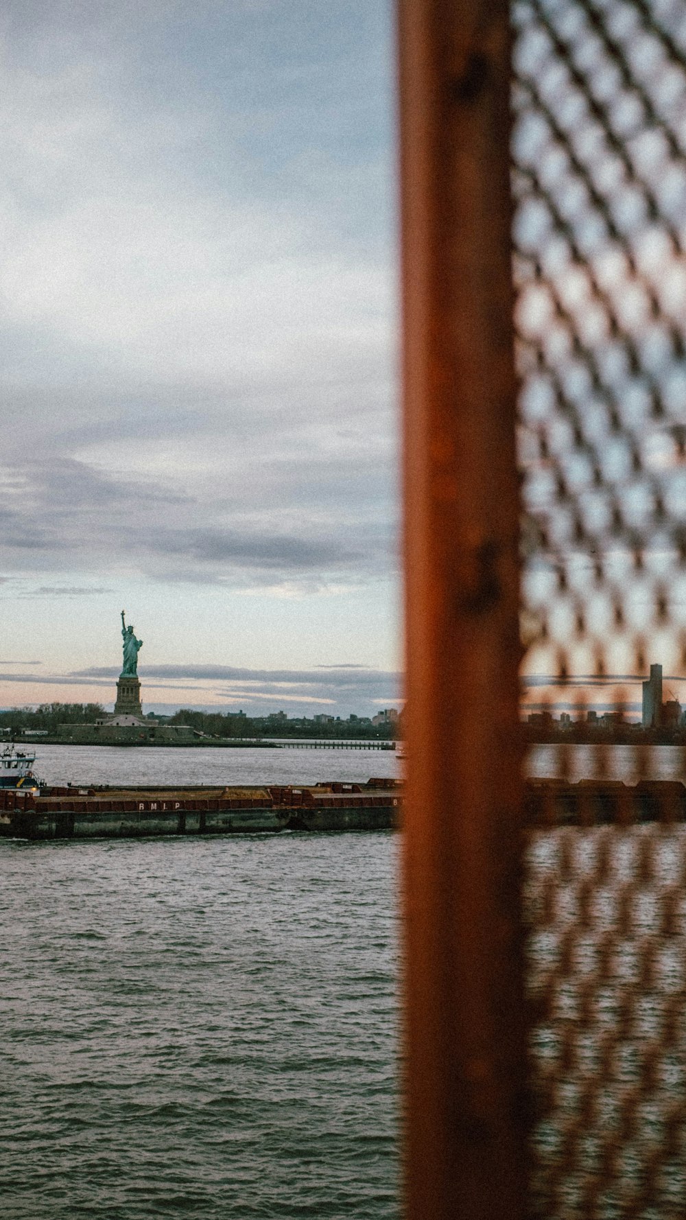 a view of the statue of liberty from across the water