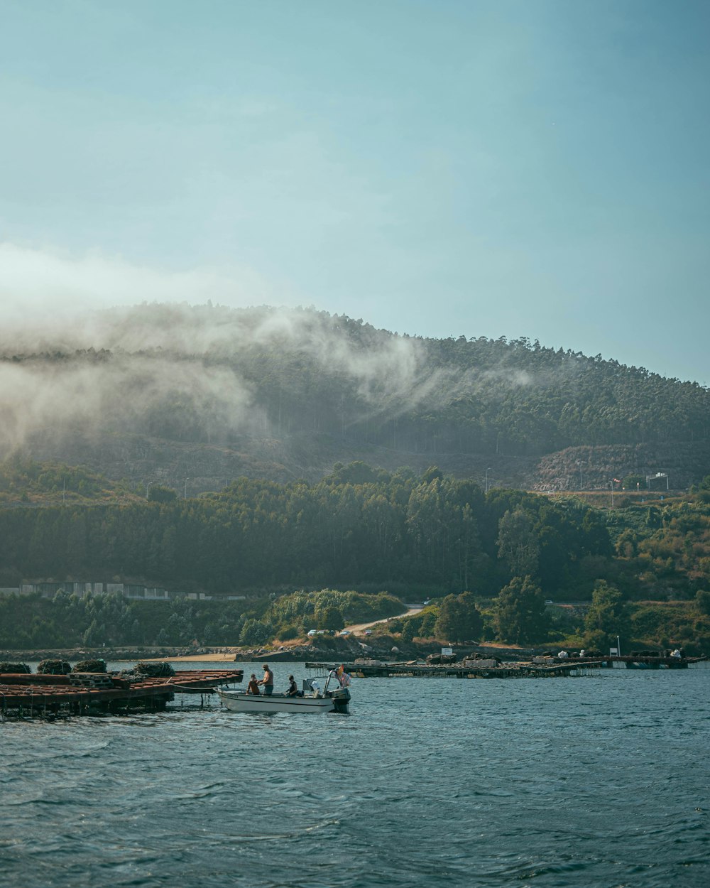 a group of boats floating on top of a lake