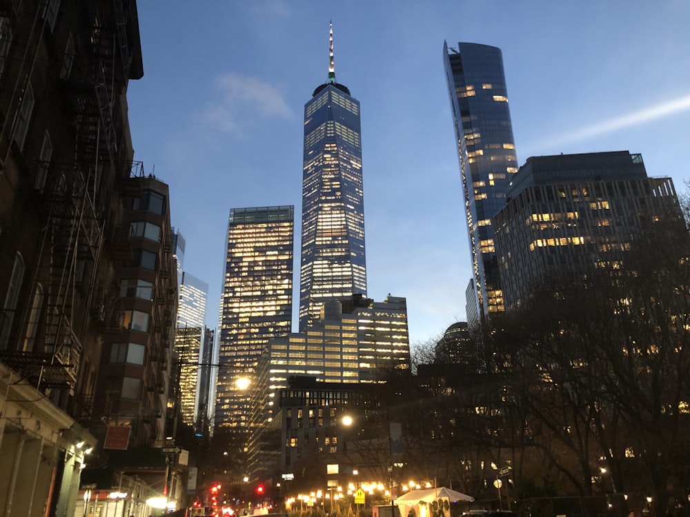 a very tall building towering over a city at night