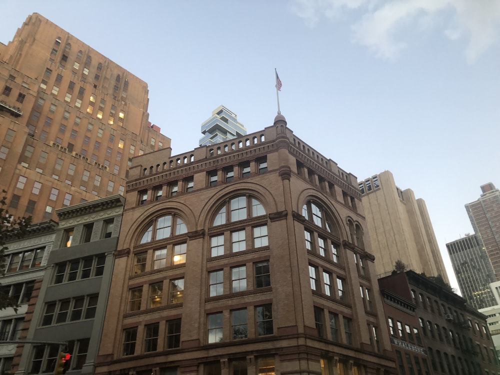 a tall building with a flag on top of it