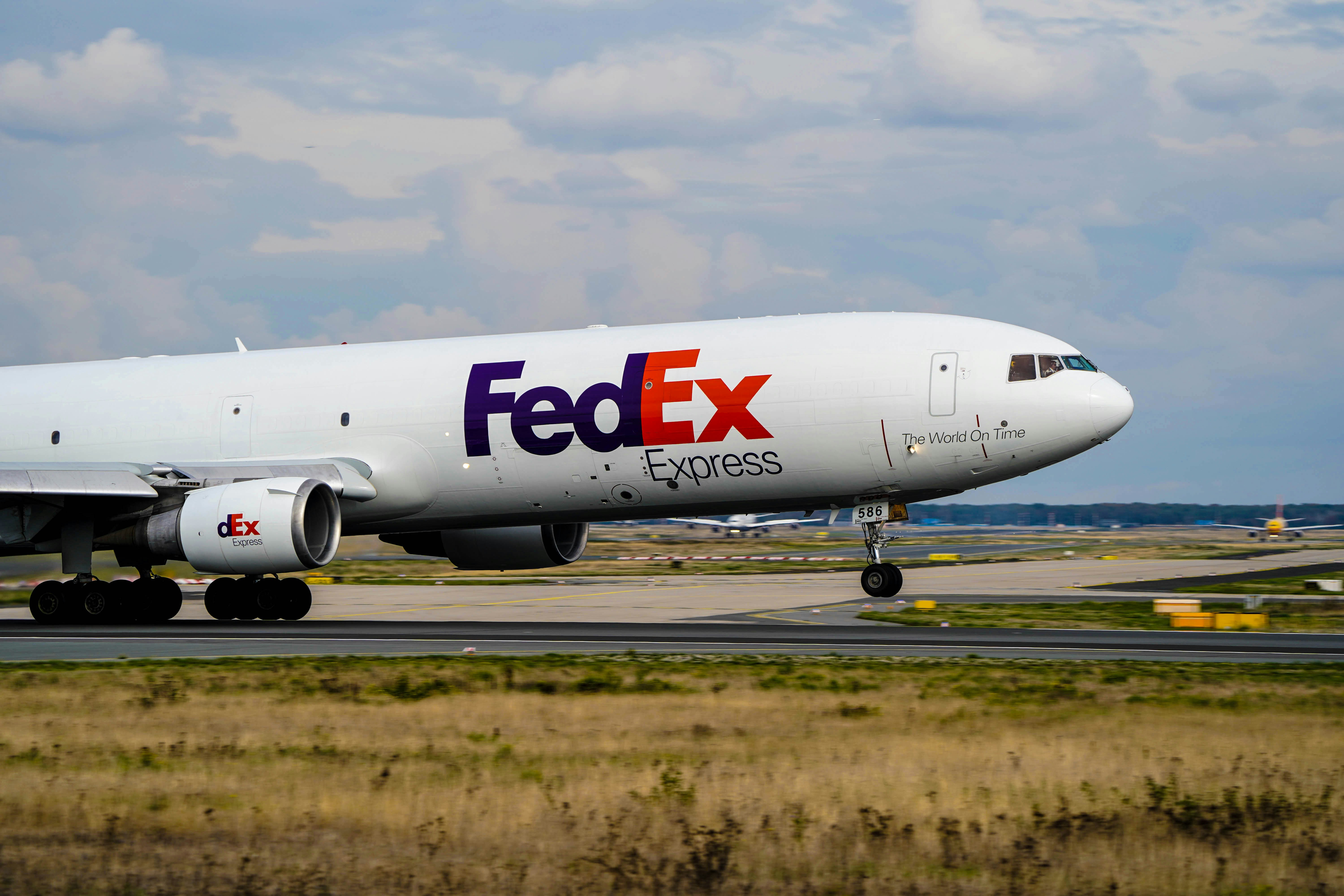 a fed ex airplane is on the runway, FedEx Express McDonnell Douglas MD-11 during takeoff in Frankfurt [EDDF] on runway 18!