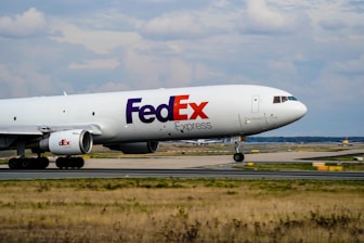 a fed ex airplane is on the runway