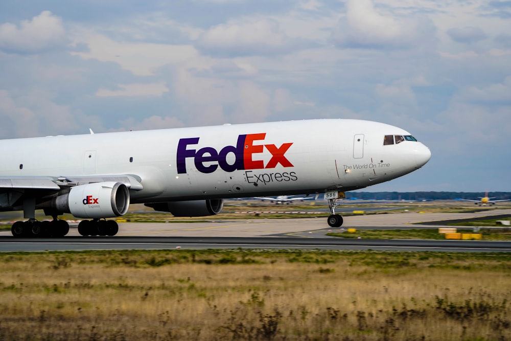 a fed ex airplane is on the runway