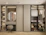 A stylish wardrobe with sliding doors and organized compartments in a cozy bedroom.