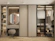 An elegant built-in wardrobe with sliding doors and organized compartments.
