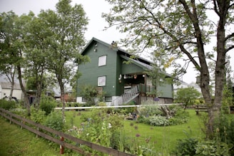 A cozy residential home surrounded by greenery and a well-maintained garden.