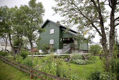 Guest house exterior surrounded by lush greenery.