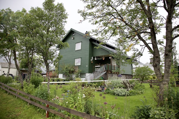 Exterior view of Breeze Inn Guest House E11 surrounded by greenery.