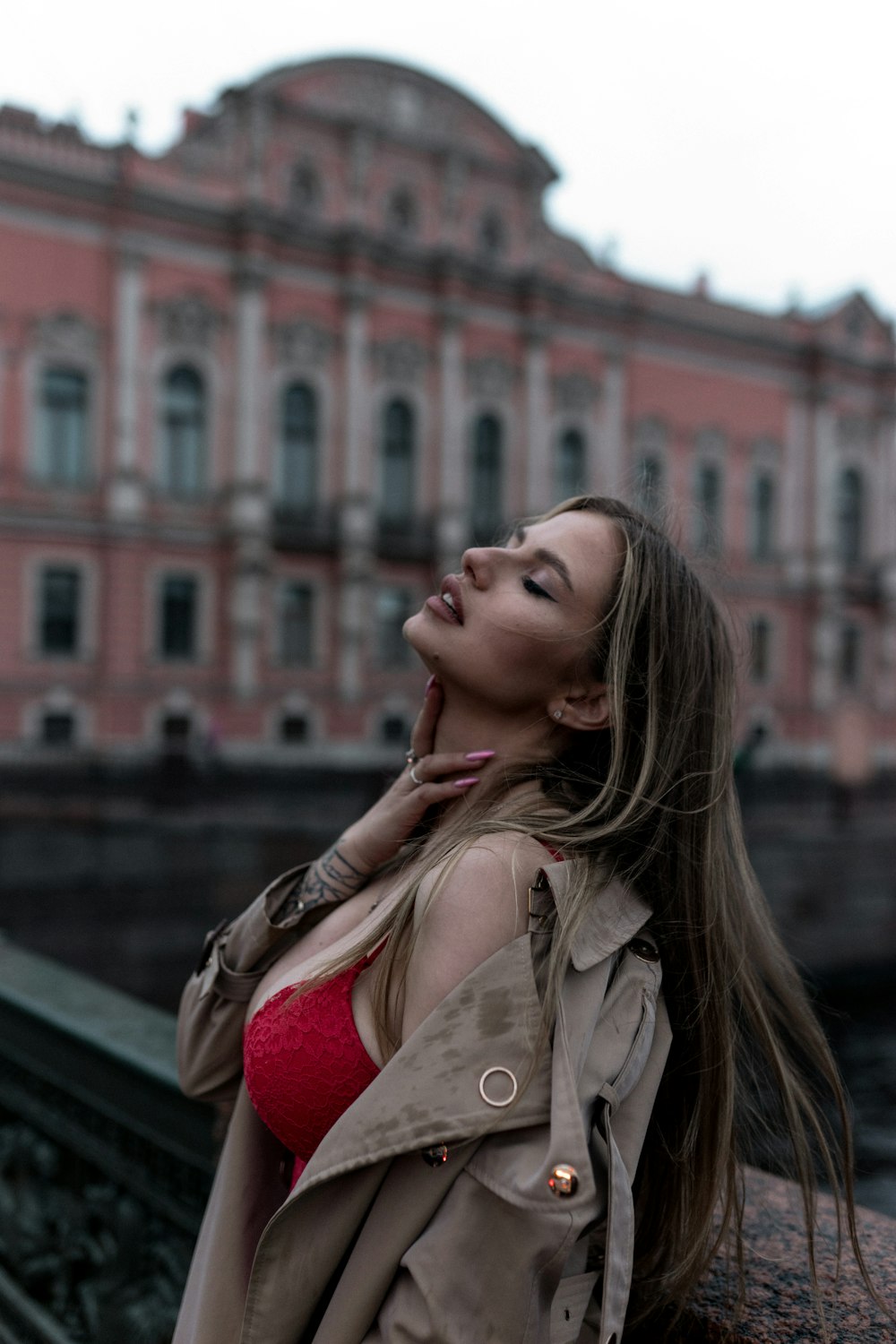 a woman in a red bikini standing in front of a building