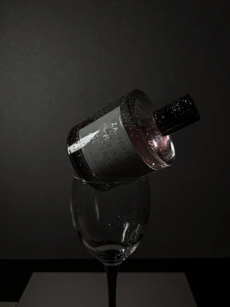 A moody evening scene with a dark perfume bottle glowing softly against a velvet backdrop.