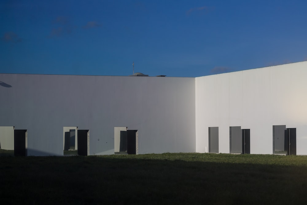 a large white building with black doors and windows