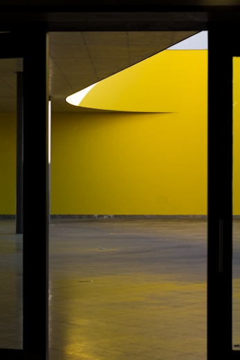 a yellow room with a clock on the wall