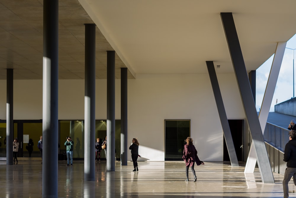 a group of people walking around a building