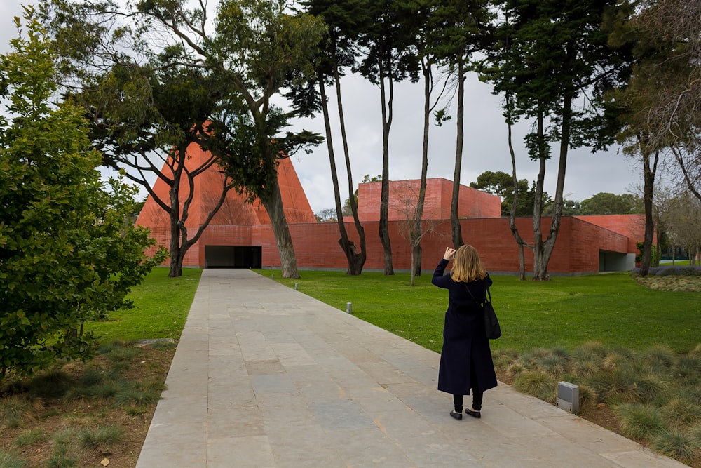 a woman is taking a picture of a building