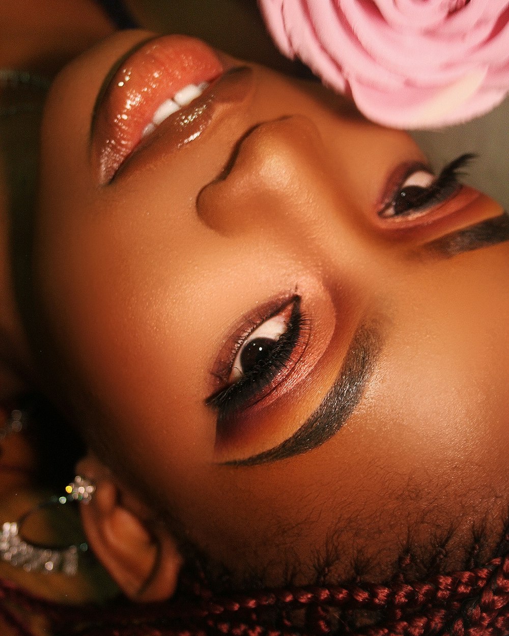 a close up of a woman with a flower on her head