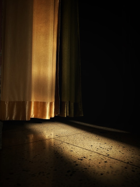 Thermal insulated curtains softly glowing in the afternoon light, highlighting their thick, cozy fabric