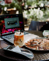 A cozy cabin porch with a laptop and a steaming cup of coffee, inviting connection.