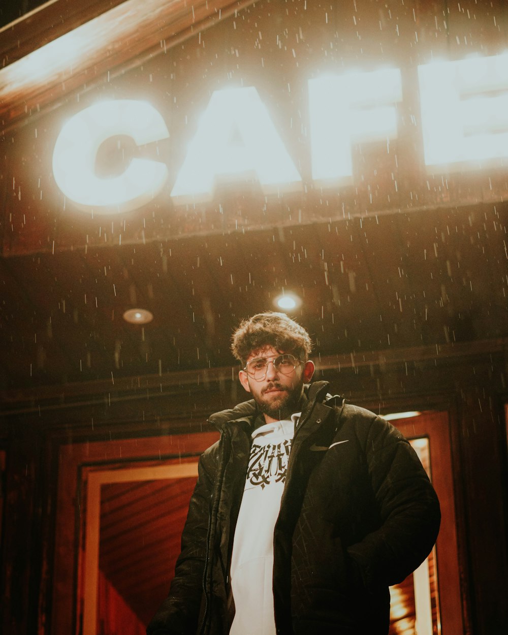 a man standing in front of a building in the rain